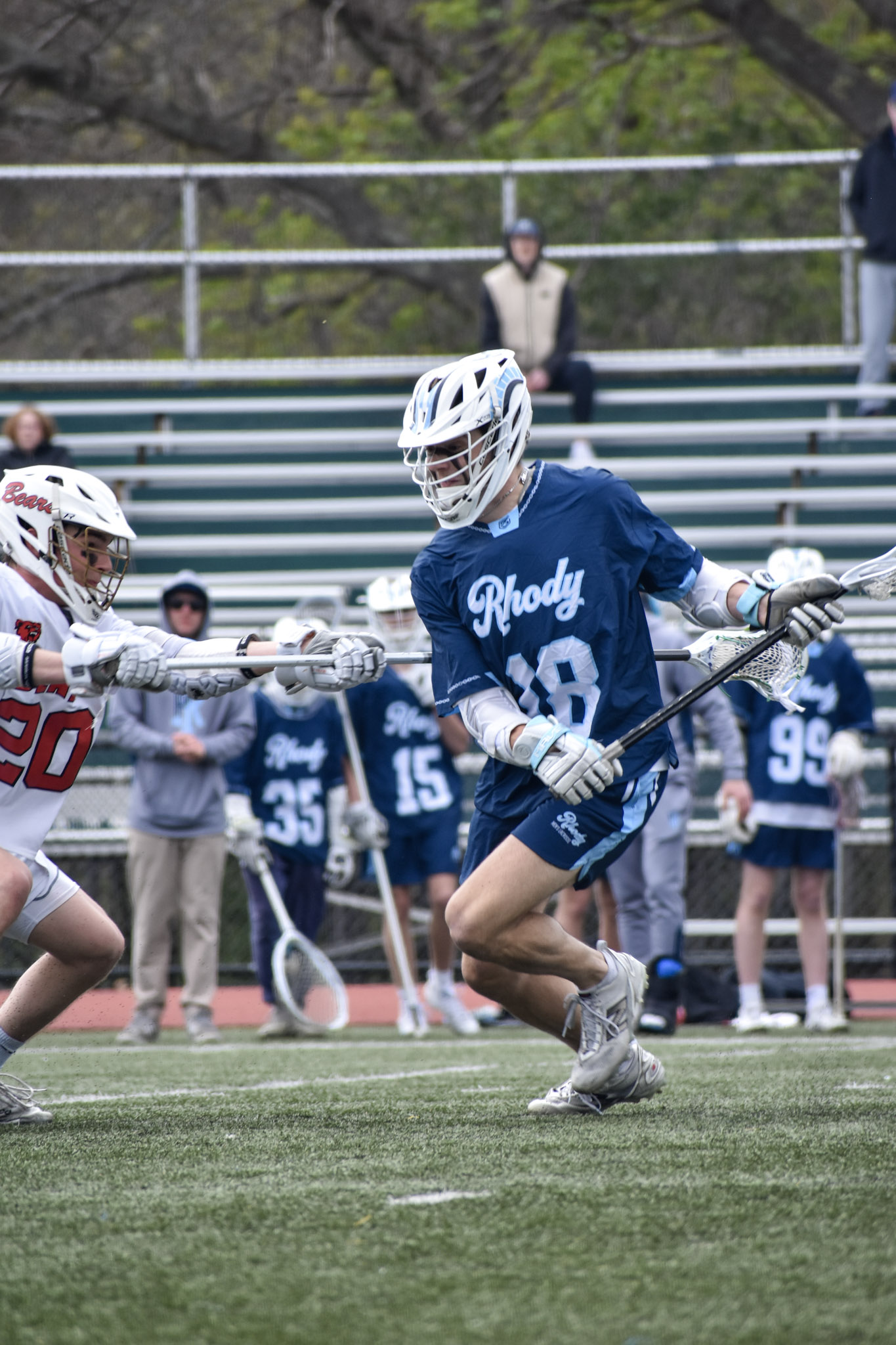 Nathan Segar carrying the ball during a URI Men's Lacrosse game