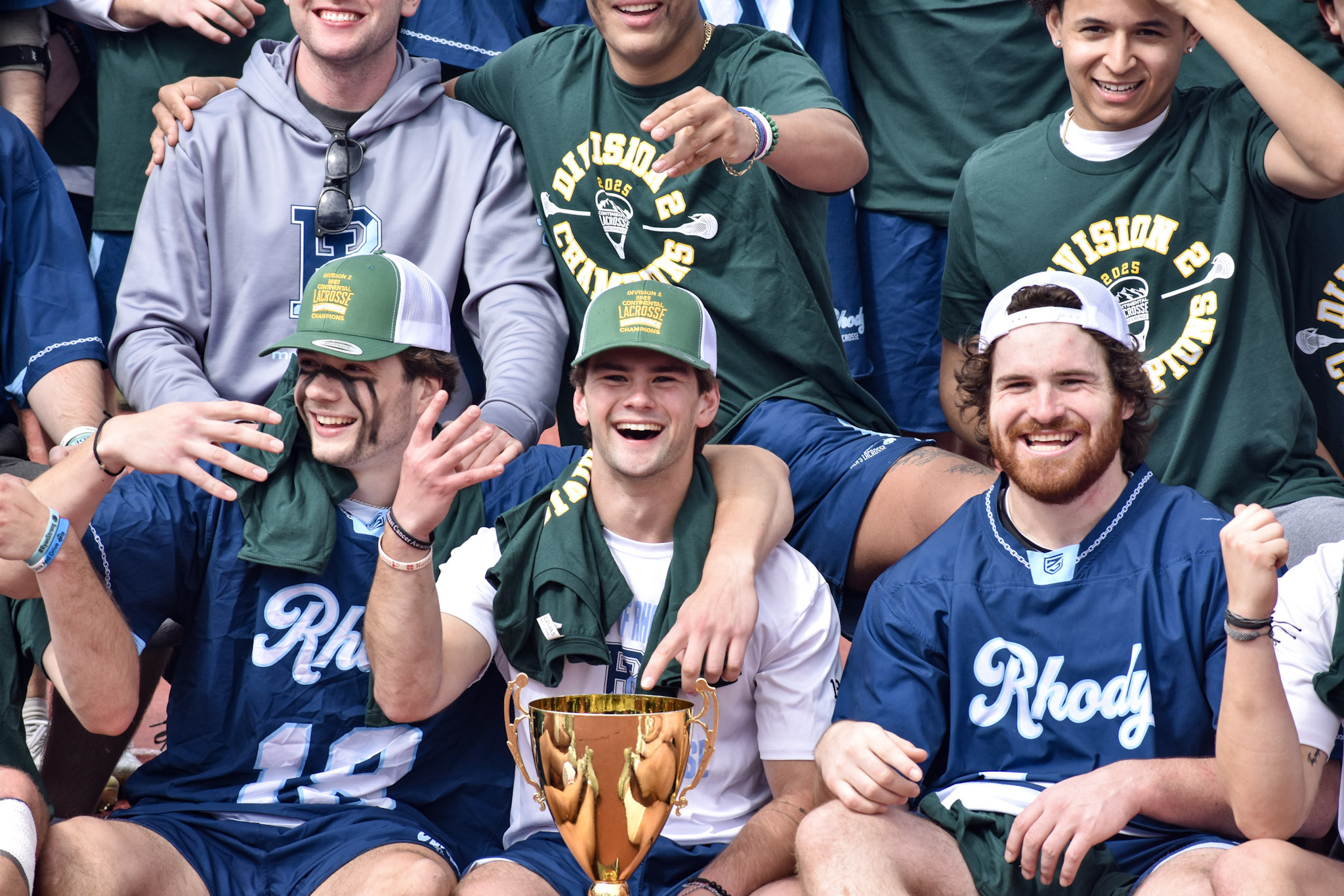 URI Men's Lacrosse players celebrating together after winning a conference championship